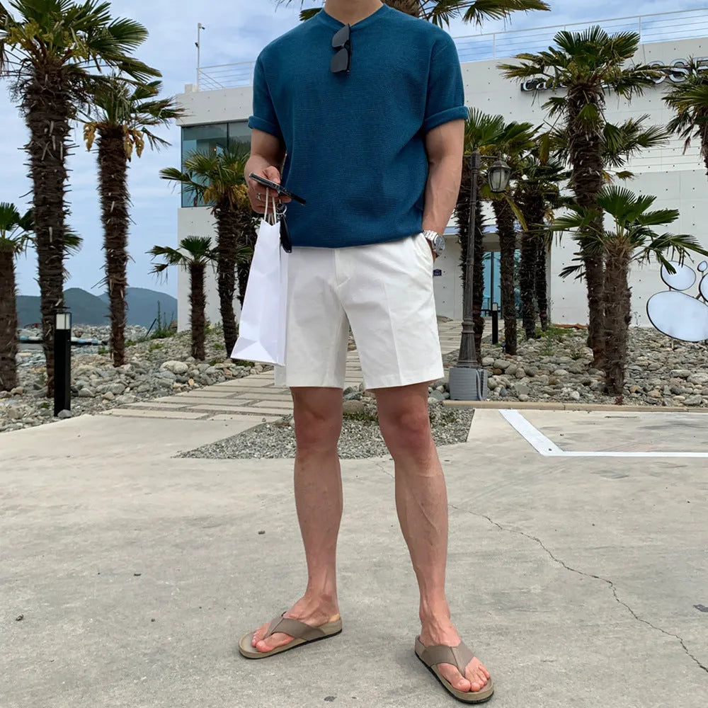 Men's straight-leg polyester shorts in solid black colour showing loose casual fit