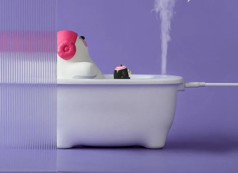 White plastic USB air humidifier with water tank on a desk