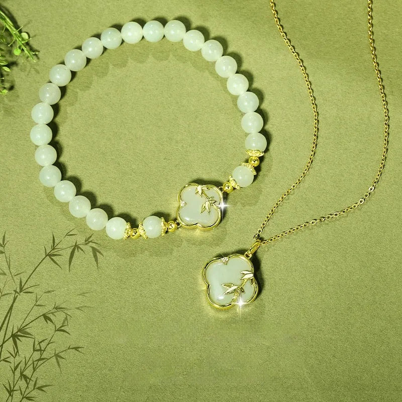 Hetian Jade festival bracelet and necklace set with inlaid jade leaf designs on bamboo newspaper tone background