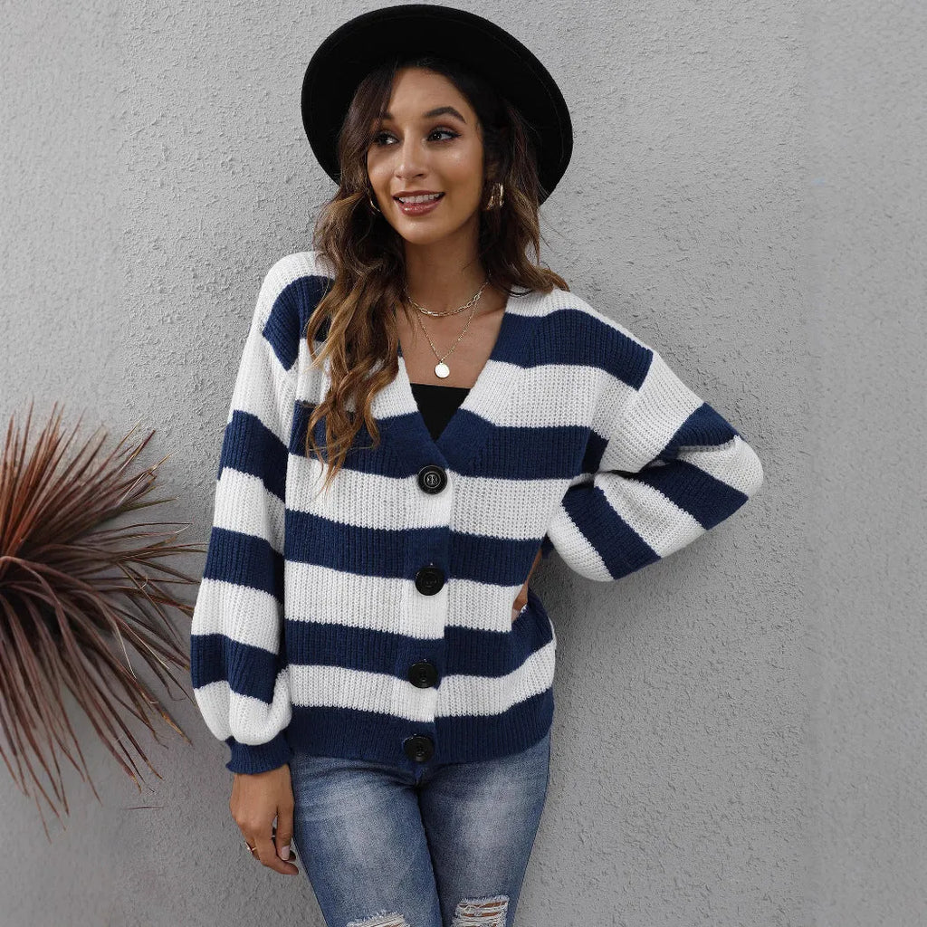 Blue striped women's cardigan sweater with buttons, shown on a hanger.