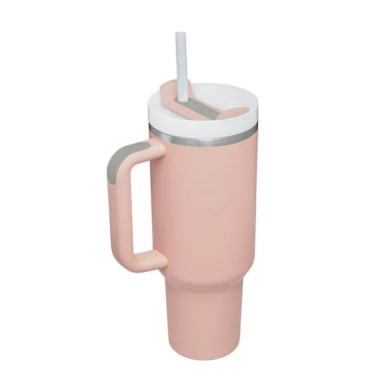40 oz stainless steel insulated tumbler with a black handle, straw, and grey lid on a wooden table