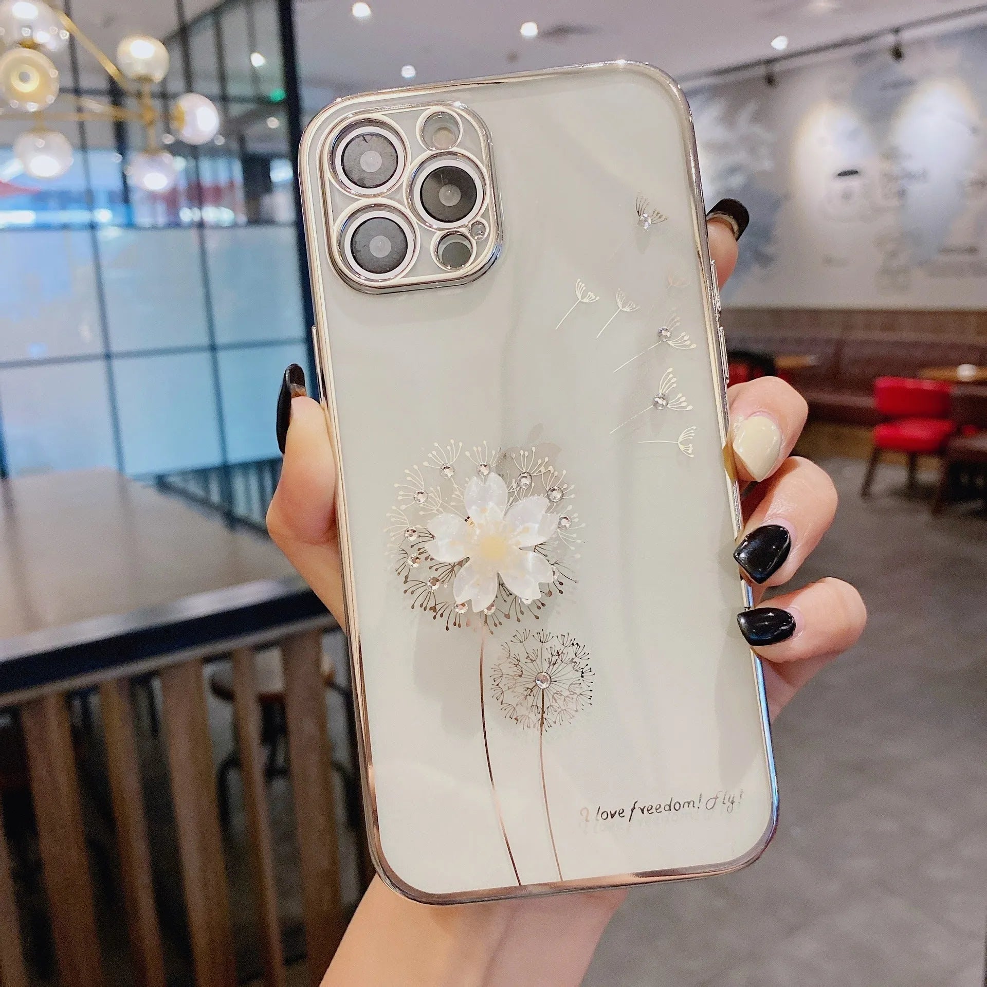Green iPhone case with 3D white floral design and a silver rotating kickstand extended at the back.