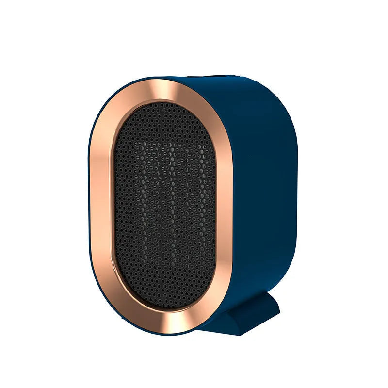 A compact black desktop ceramic fan heater with a mechanical control dial and a UK plug.