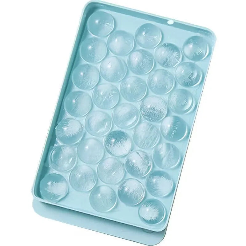 Blue silicone ice cube tray with lid showing 33 round grids for making ice.