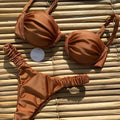 Women's black underwire bikini swimsuit with split brief style on a mannequin.