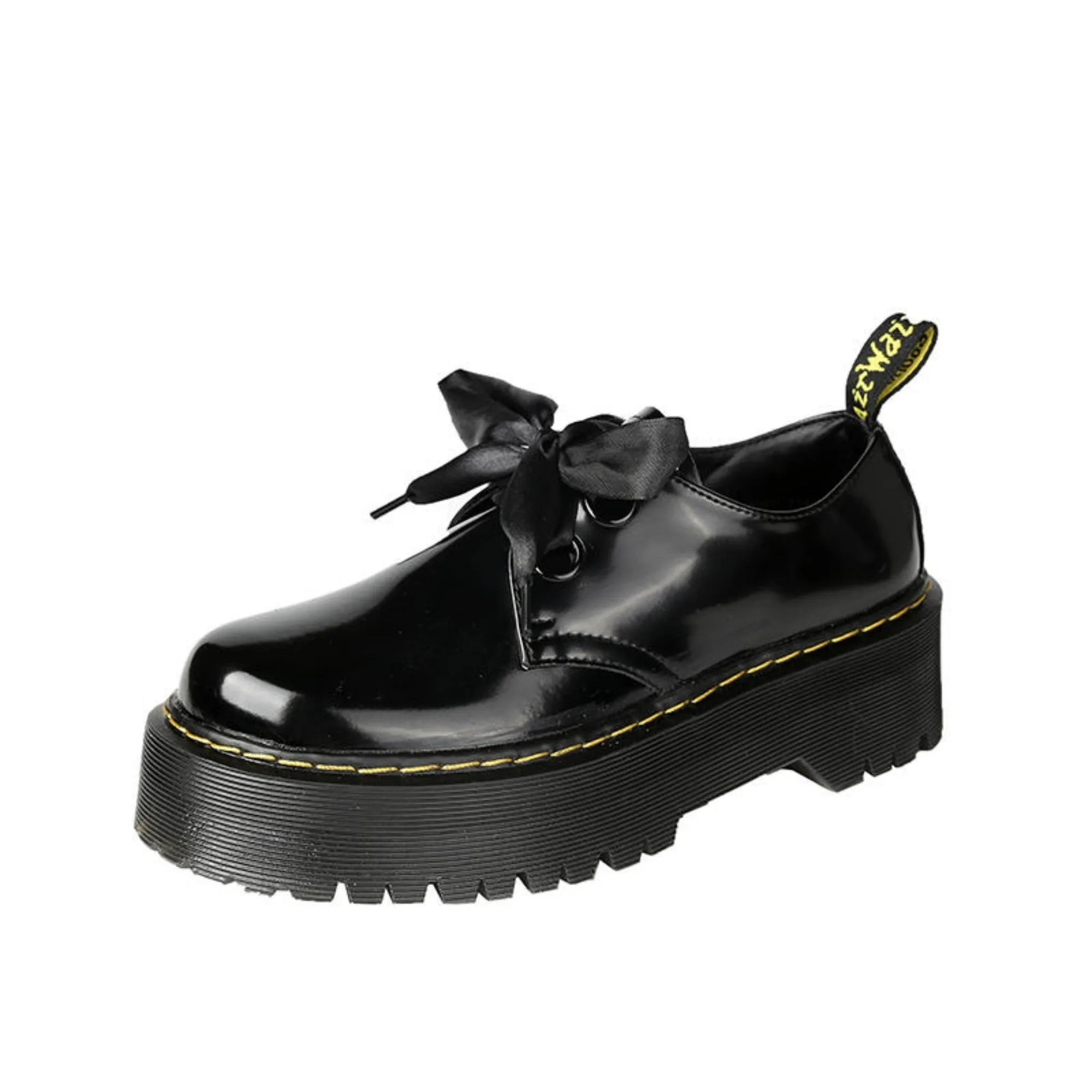 Women's black thick-soled leather shoes with ribbon and cross-strap details on a white background.