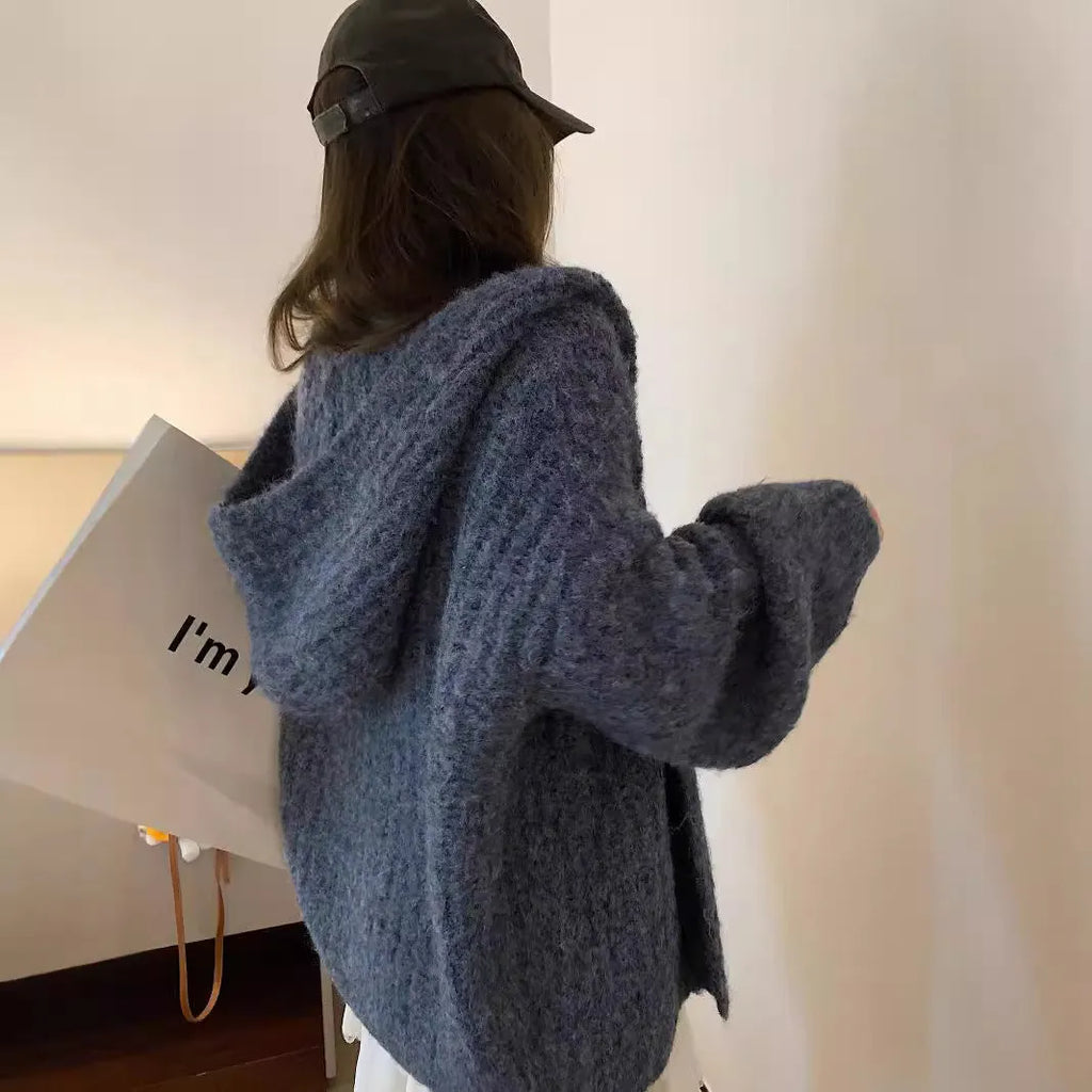 A woman's loose-fitting, hooded sweater cardigan in a solid colour, shown with regular sleeves.