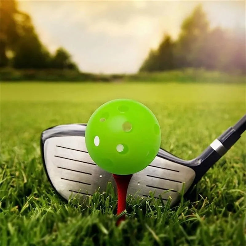 Assortment of red, orange, blue, green, white, and yellow 42mm golf practice balls in a net.