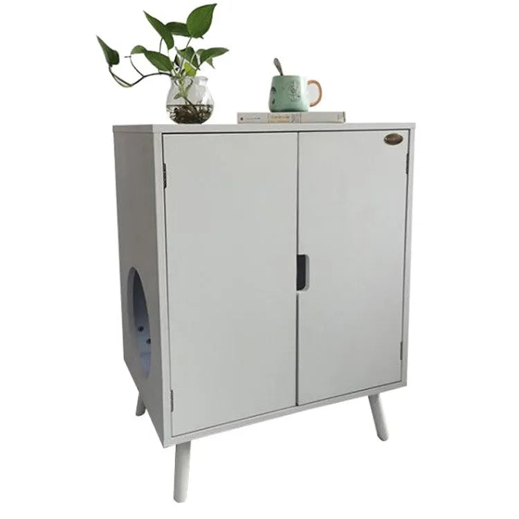 Wooden cat nest cabinet in ivory finish, with front opening for cat access, on a wooden floor