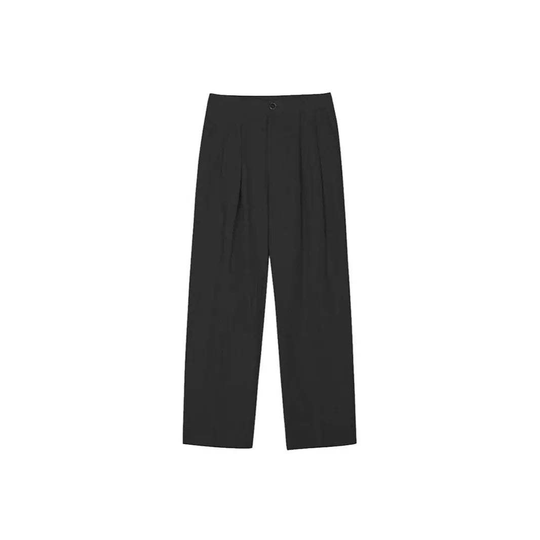 Men's apricot coloured loose-fit cotton linen suit trousers with a pencil leg on a neutral background.