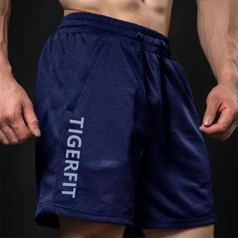 Men's loose-fit quick-dry sports shorts in black polyester fabric on a hanger