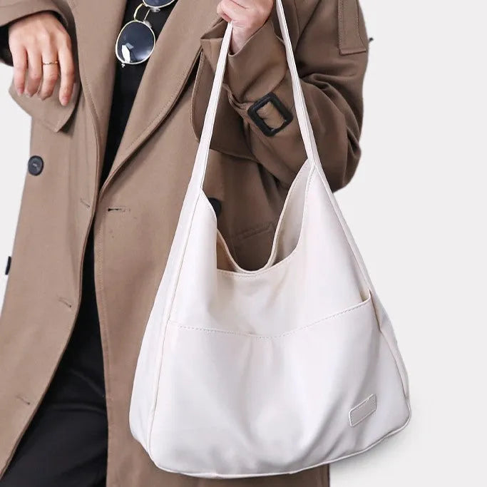 Women's soft PU shoulder bag in retro style with open pocket, shown in one of four colours