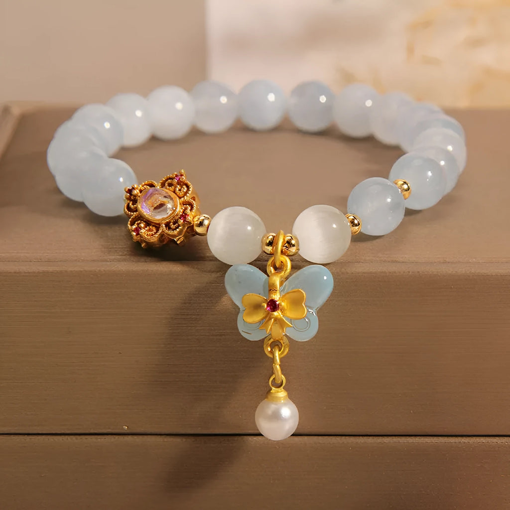 Women's aquamarine butterfly pendant crystal bracelet with rhinestone detailing on adjustable chain