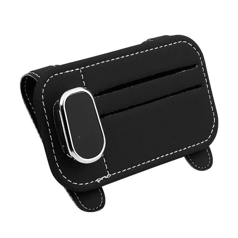 Beige cowhide automotive sun visor clip holding cards and sunglasses.