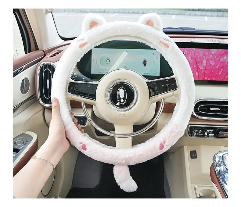 Plush winter steering wheel cover with embroidered bear design, shown on a car steering wheel.