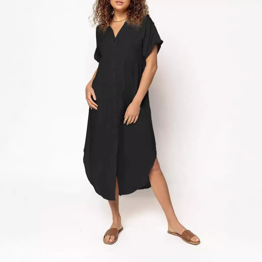 Loose-fitting mid-length casual dress with button front detail on a hanger.