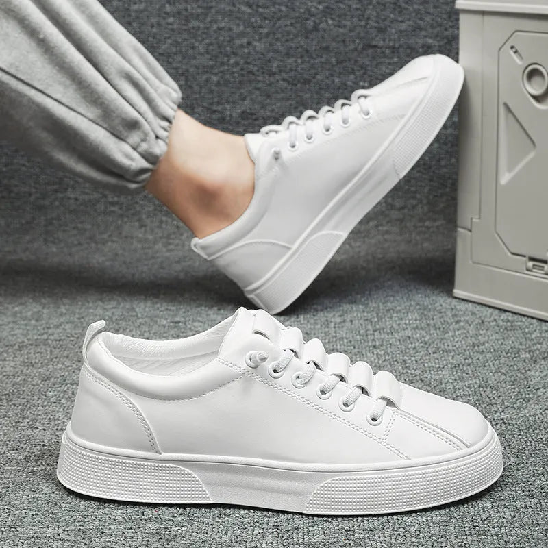 Men's black and white low top synthetic leather sports shoes with mesh panels and a PVC sole.