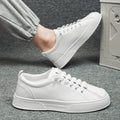 Men's black and white low top synthetic leather sports shoes with mesh panels and a PVC sole.