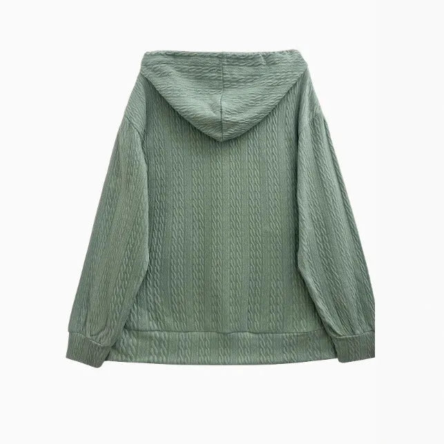 Green women's hooded zip-up coat with a loose fit, long sleeves, and a front zipper on a neutral background.