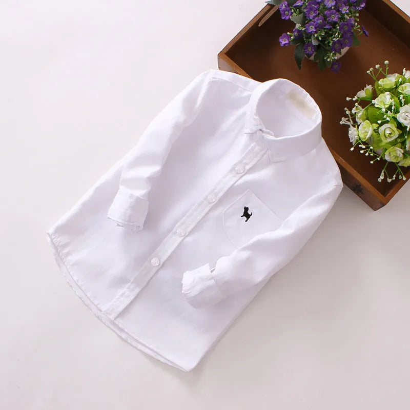 Boy's blue long-sleeved cotton shirt with lapel collar shown on a hanger.