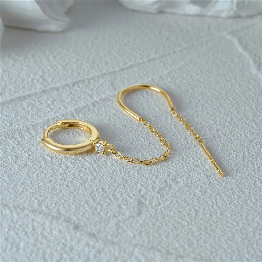 S925 sterling silver ear stud with geometric diamond flower, tassel, and chain design in a gold colour.