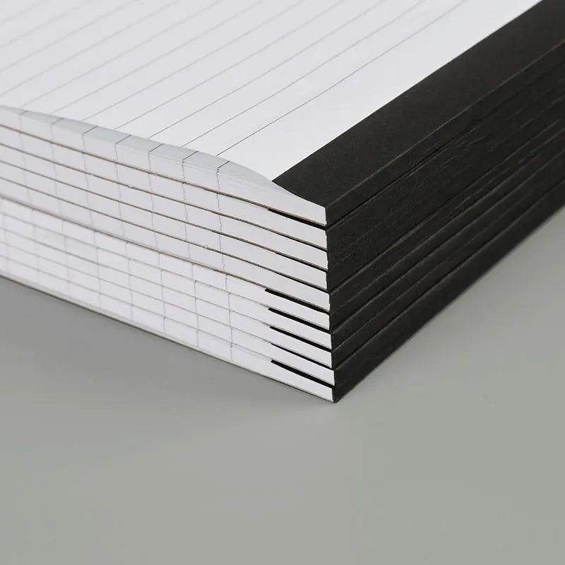 A4 tearable notebook with a paper cover and ivory white grid pages, showing adhesive binding.