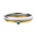 A geometric titanium steel ring with a December birthstone colour, gold electroplated handle, and engraved steel lettering.
