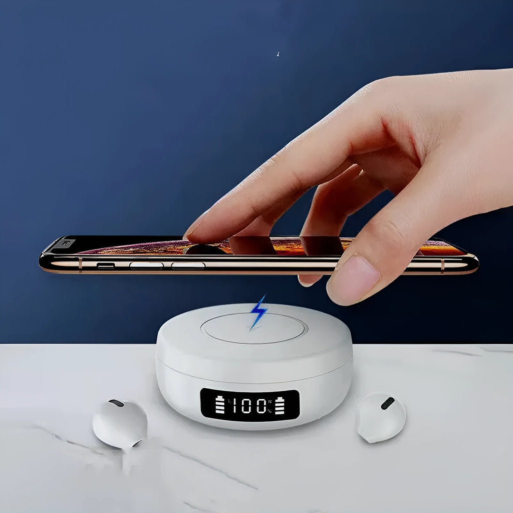 Black wireless semi-in-ear headphones next to their white charging case on a table.