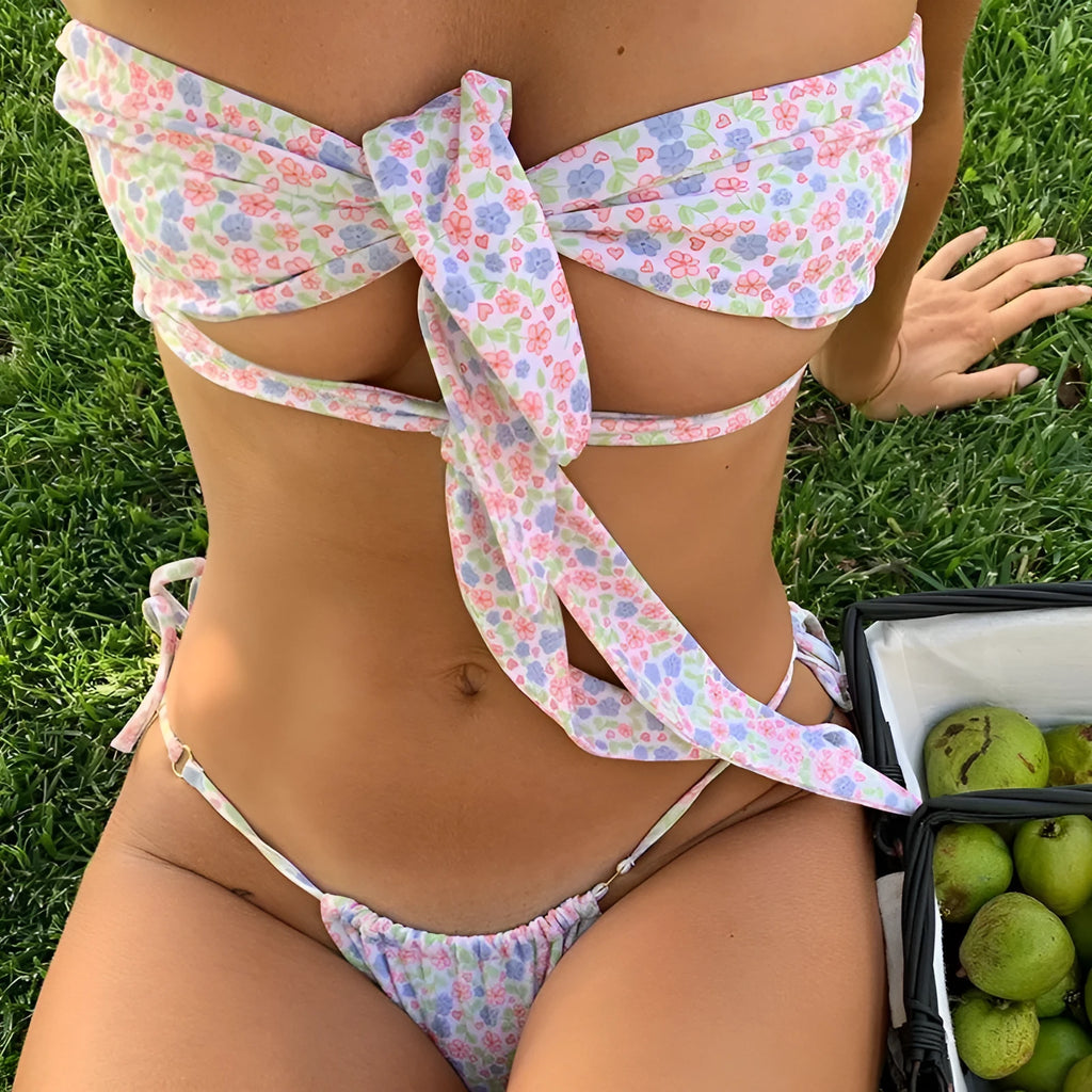Women's blue floral print swimsuit with front lace-up closure and brief-style bottom.