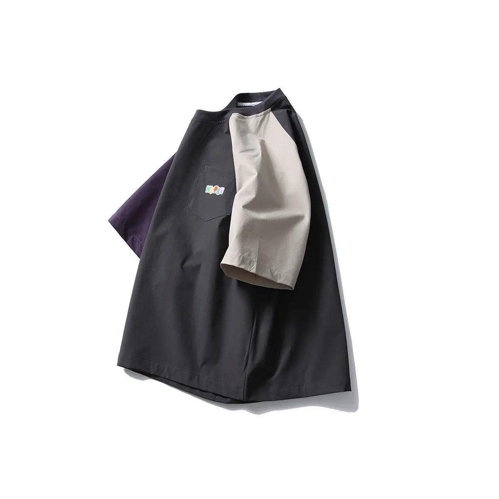Dark grey men's loose-fit T-shirt with contrast raglan sleeves on a hanger.