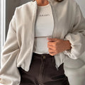 Women's off-shoulder short coat with lantern sleeves and round neck in brown.