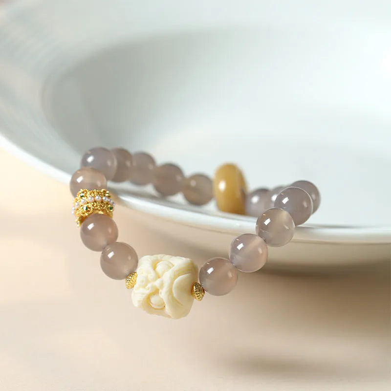 Hand-woven gray agate and mellite bracelet with 10mm round beads