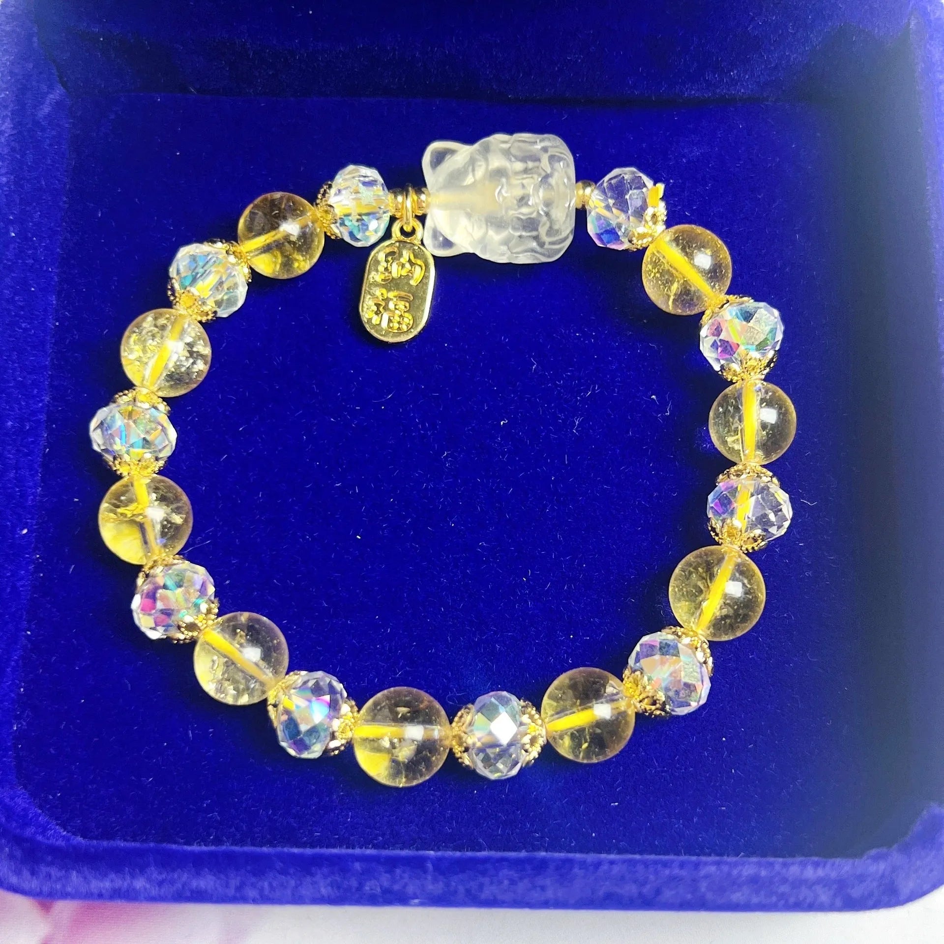 Handmade natural citrine crystal bracelet with detailed nine-tail fox design on a white background.