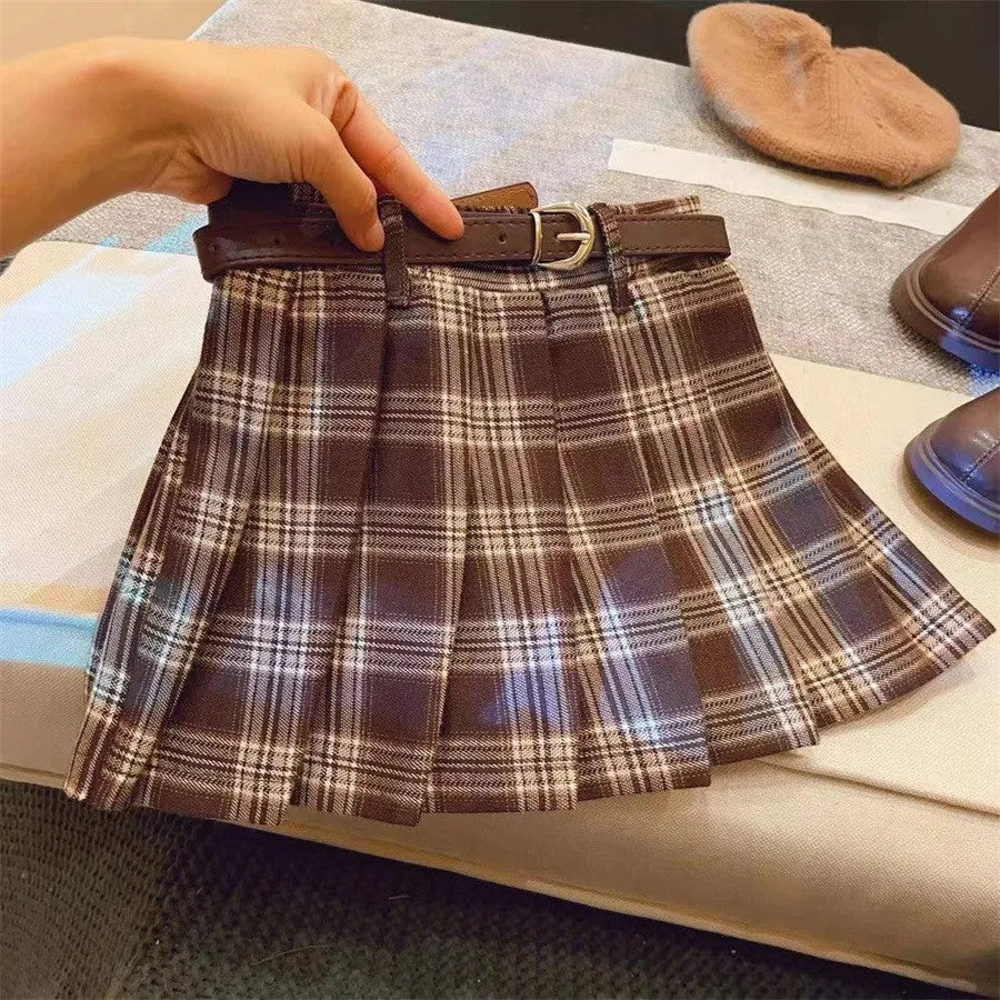 Girls' red and black plaid pleated A-line skirt made from cotton blend fabric.
