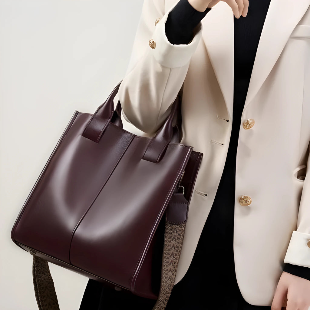Women's genuine leather shoulder tote bag in black colour showing bucket design and polyester lining