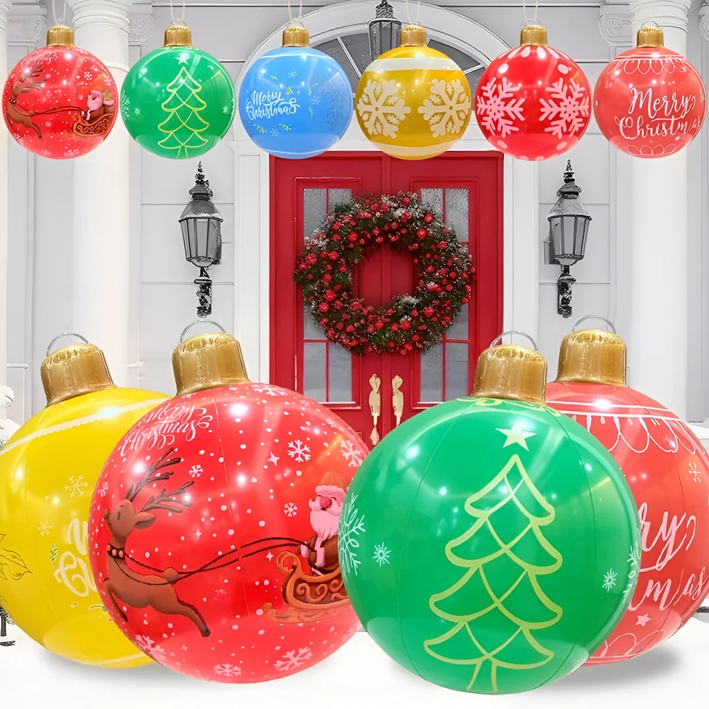 Large red inflatable Christmas ball with flashing LED lights standing in a garden.