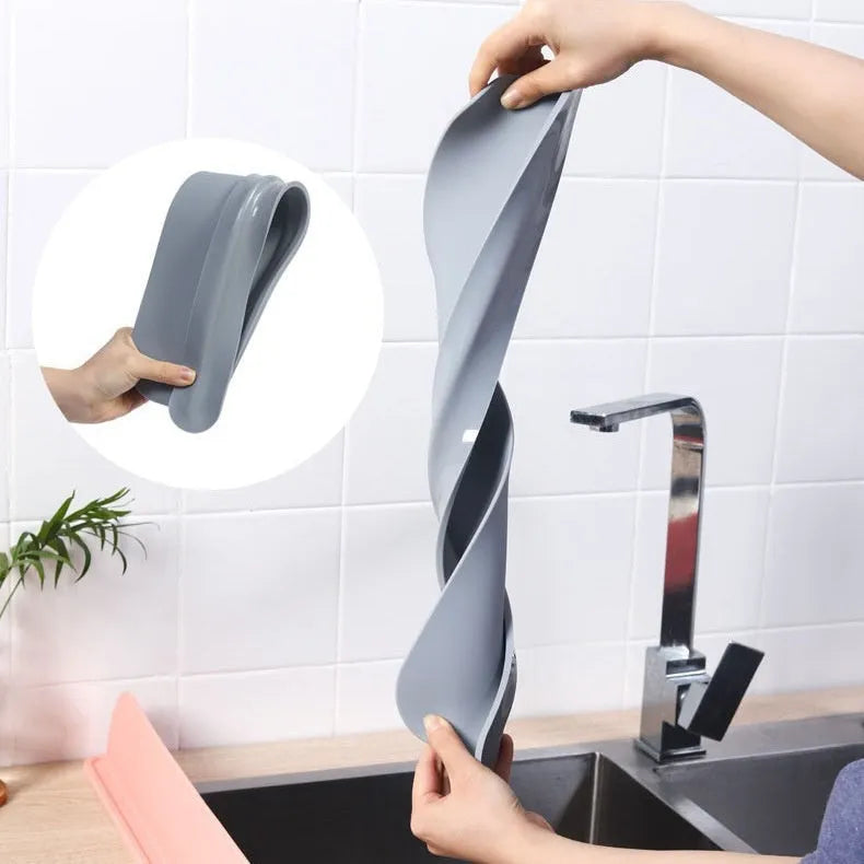 A thick grey silicone water blocking plate for a kitchen sink, showing its size and non-slip base.