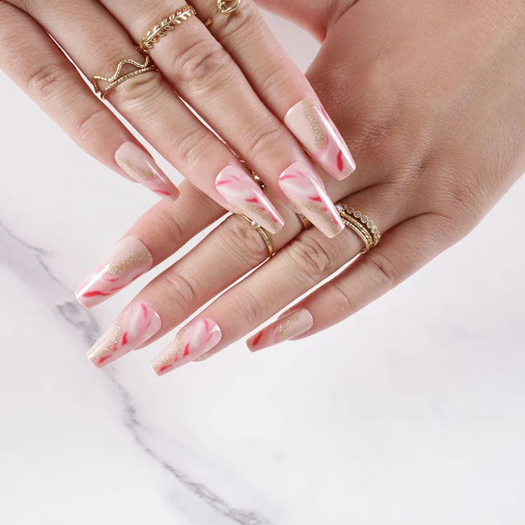 Wearable manicure set showing 24 false nails in various patterns with glue bottle
