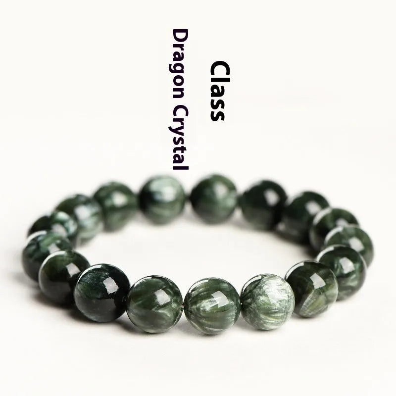 A bracelet made of polished green dragon crystal round beads with a geometric Ruyi design element.