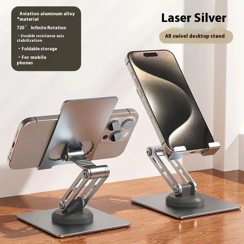 Aluminium alloy rotating mobile phone bracket in silver on a desk, showing three-axis joint and metal texture finish