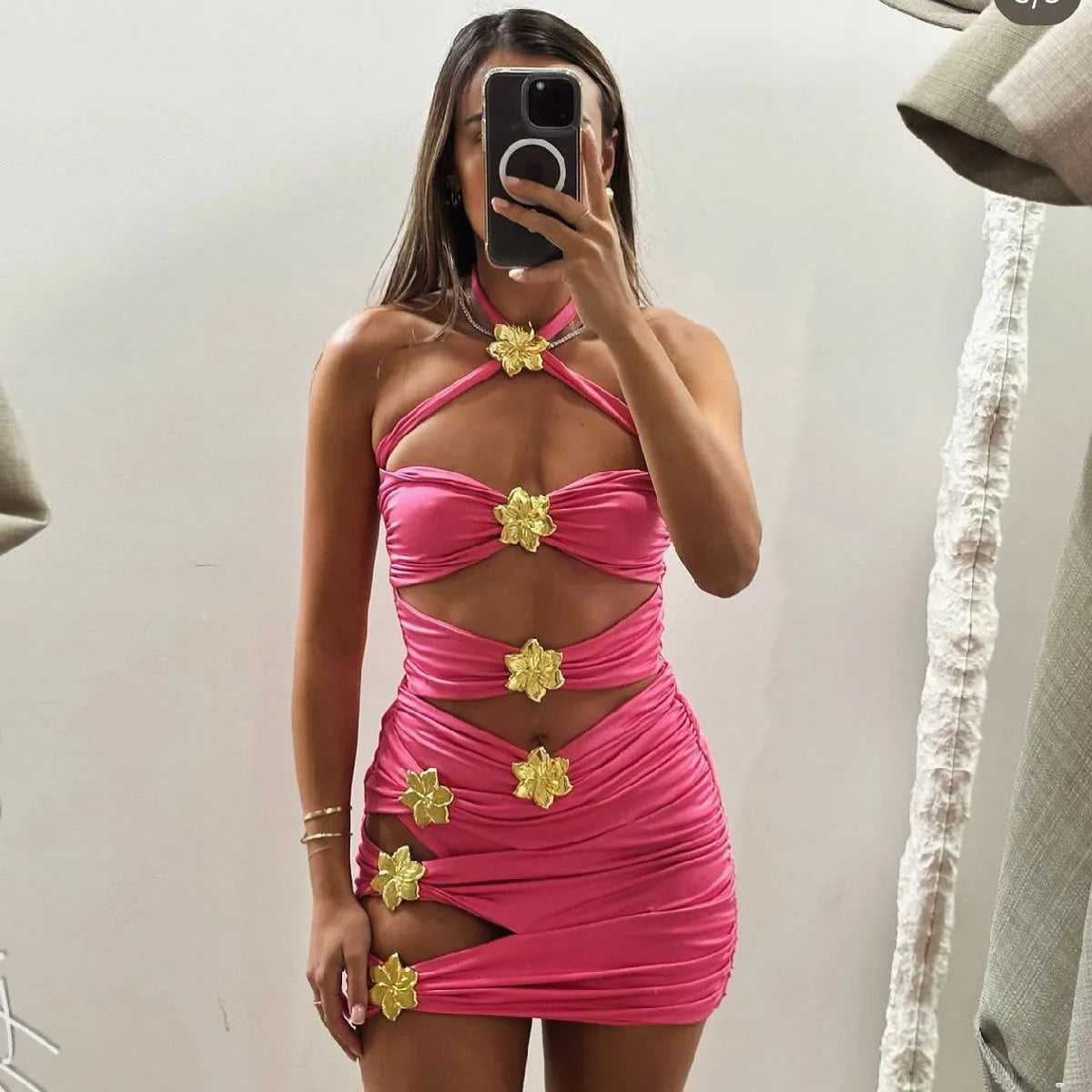 A women's solid colour one-piece swimsuit with a detachable skirt and hollow-out tube top.