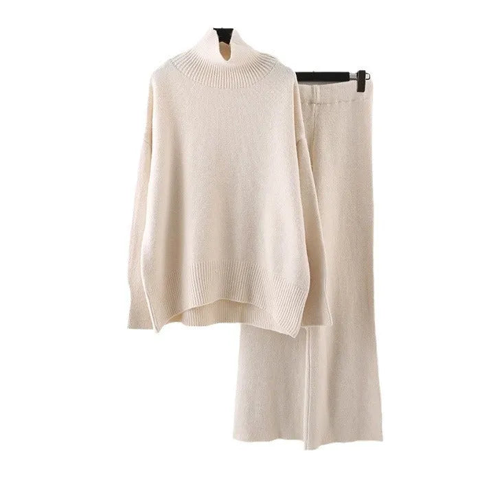 Women's milky white acrylic knit two-piece set featuring a long-sleeve sweater and wide-leg trousers on a hanger.