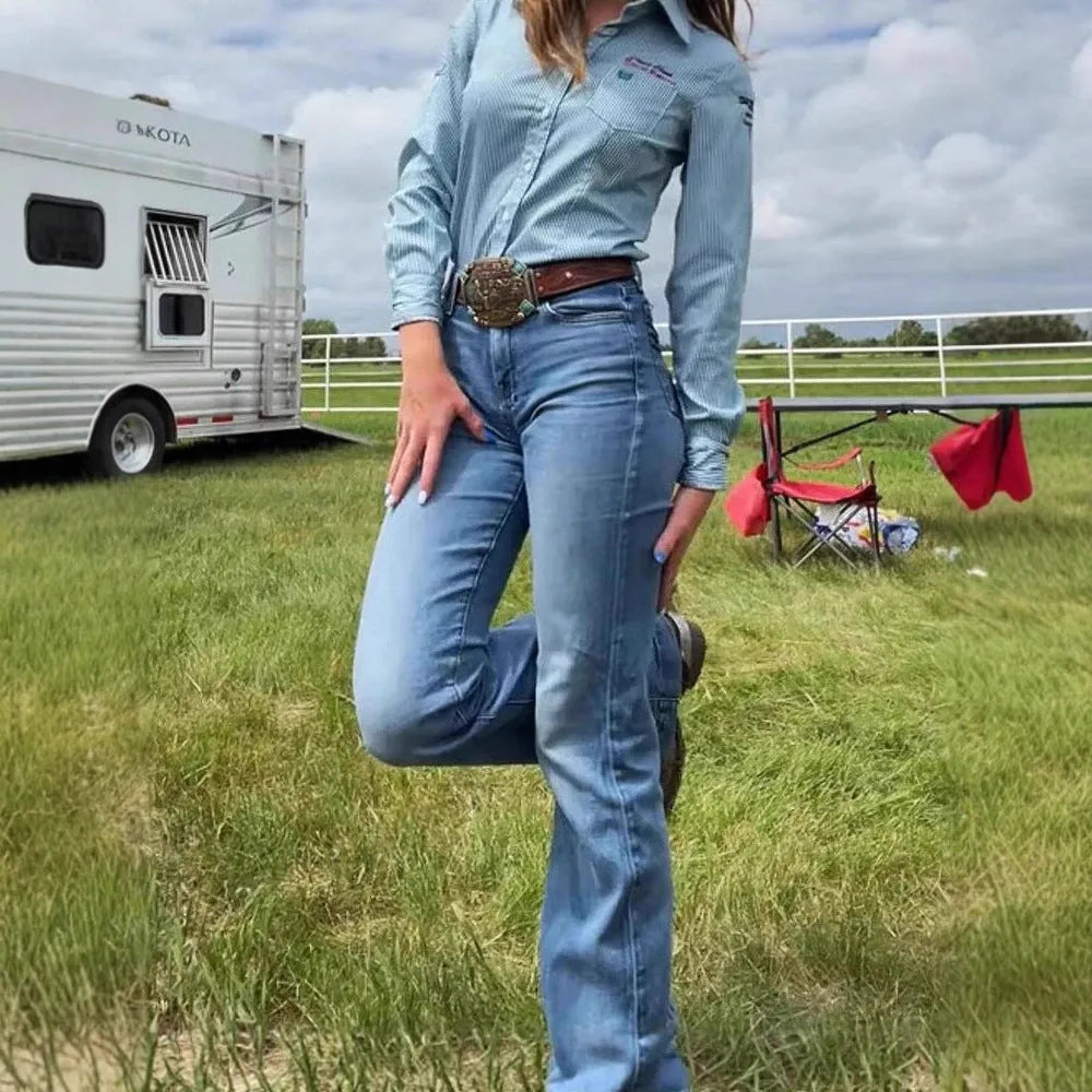 Slim fit blue embroidery jeans with a slight flare and elastic mid-waist.