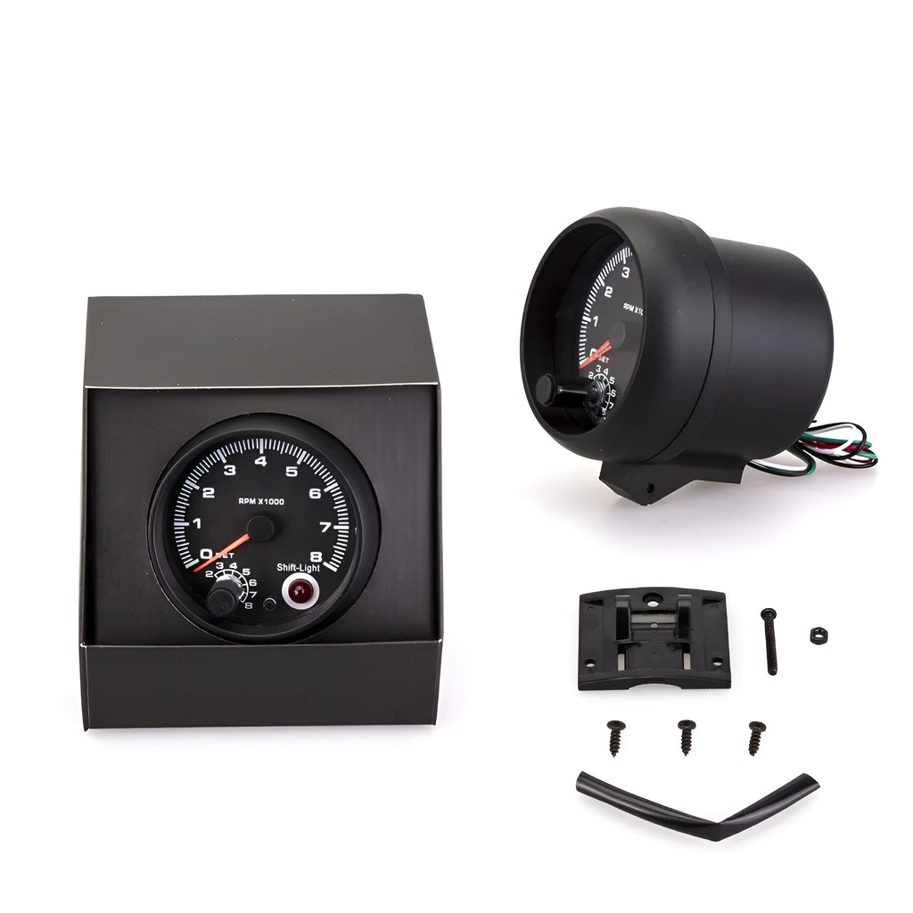 Black automotive tachometer with blue light pointer dial for measuring engine RPM.