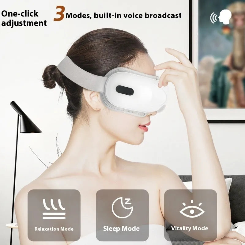 White rechargeable eye massager with hot compress and airbag massage functions on a table