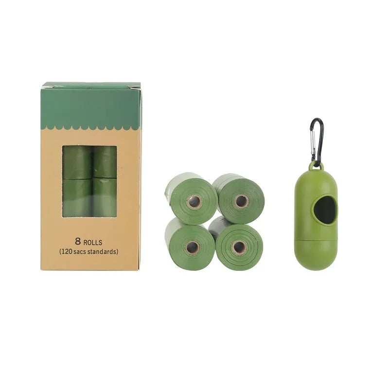 Roll of green EPI degradable pet poop bags next to a transparent dispenser on a dog lead.