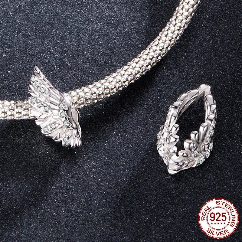 S925 sterling silver wing bead inlaid with zircon on a white background showing 1.4cm size