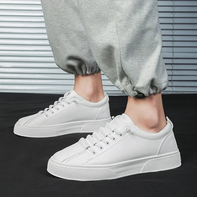 Men's black and white low top synthetic leather sports shoes with mesh panels and a PVC sole.